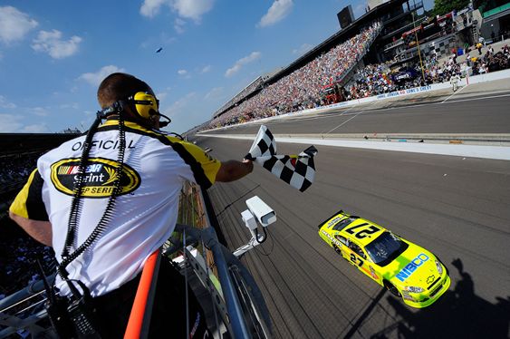 Paul Menard, driver of the No. 27 NIBCO/Menards Chevrolet, takes the checkered flag as he crosses the finish line to win the NASCAR Sprint Cup Series Brickyard 400 at Indianapolis Motor Speedway on July 31 in Indianapolis, Ind. Credit: Jason Smith/Getty Images for NASCAR